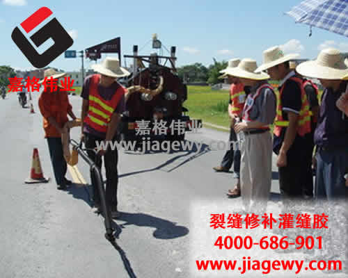 使用路面灌縫膠的養(yǎng)路工忙碌在國(guó)慶、中秋節(jié)日的路上